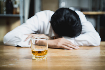 drunkard fall asleep on the table at bar.