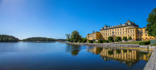Fototapeta na wymiar Stockholm’s Drottningholm Palace reflecting on the lake water