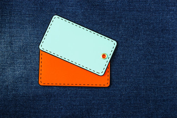 Double blank tag label on jeans background.