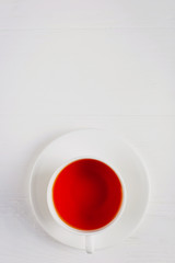 A cup of tea on a white wooden table.