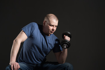 Fototapeta na wymiar Young male dumbbell in his hands