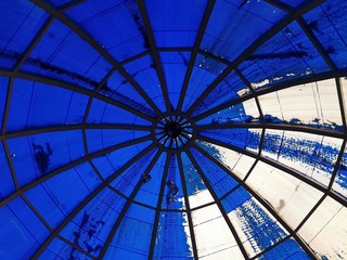 The blue paint on the roof of a spherical shape was erased by a quarter.