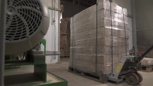 A demonstration video of pressed sawdust briquettes picked up with hand pallet truck