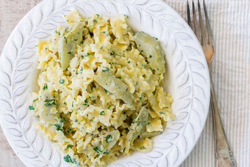 A plate with pasta and artichokes from above.