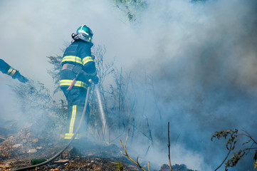 Firefighter extinguishes a fire