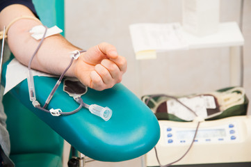 Blood donor at donation with a bouncy ball holding in hand
