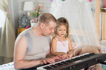 young man playing with his little daughter