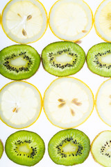 Fototapeta premium Background with lemon and kiwi. Slices of juicy lemon and kiwi top view