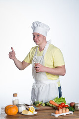 Male cook preparing dinner at the table