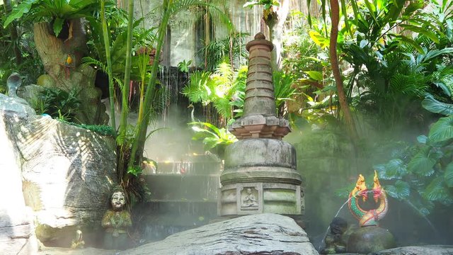 waterfall in the tropical garden of a buddhist temple