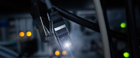 Website Header. Lan connectore close up. Datacenter server room background. RG-45