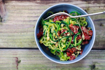 Courgette spaghetti with sun dried tomatoes and mince hazelnuts
