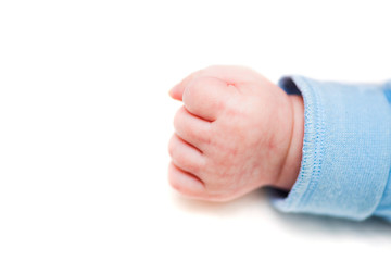 Close up of a child's fist on white background. Clenched fist - hand of child, baby power. New born baby hand