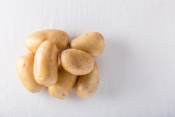 Raw organic potatoes on a white background