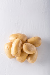 Raw organic potatoes on a white background