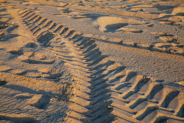 Tire tracks and footprints  on the sand