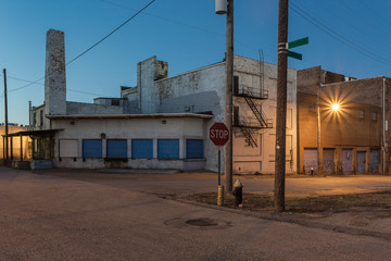 Industrial street scene in the evening with streetlight in a depressed urban area