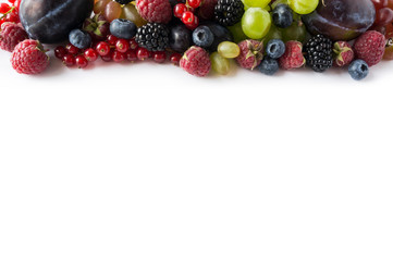 Mix berries on a white background. Ripe red currants, grapes, blackberries, blueberries, raspberries and plums on white background. Top view. Fruits with copy space for text. Mix berries and fruits. 