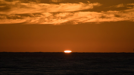 Fototapeta na wymiar Green flash as the sun sets off the pacific coast in baja Mexico. 