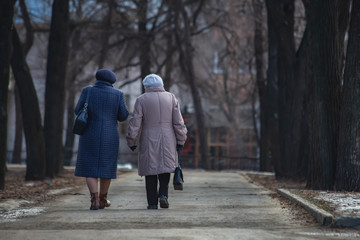 Fototapeta premium older women are walking down the street