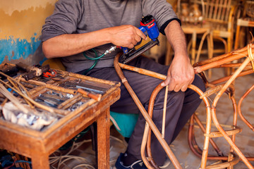 Furniture rattan chair and table decoration in process of manufacturing