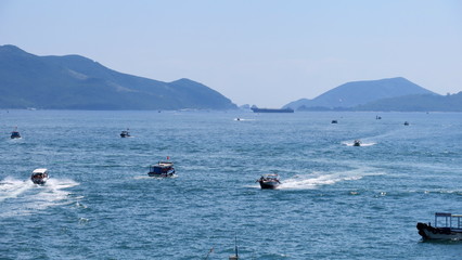 Small boats in the sea near Nha Trang Vietnam in the harbour with islands