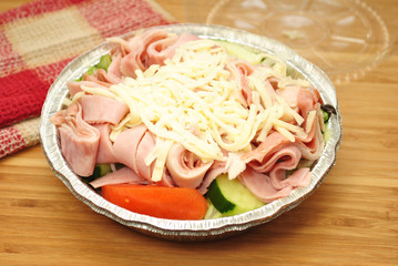 Appetizing Takeout Salad with Vegetables, Meat and Cheese 