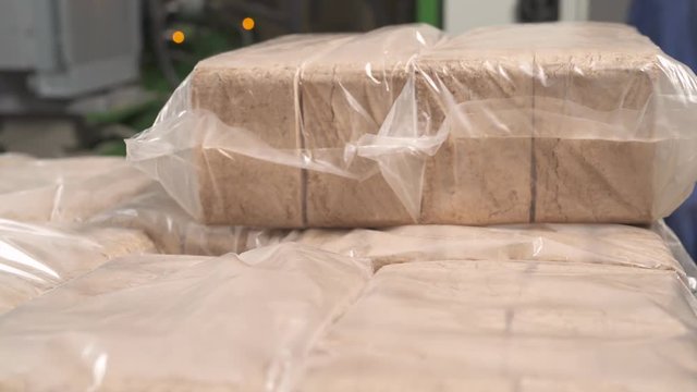 A close-up of the packed manufactured wooden briquettes. Biomass fuel.