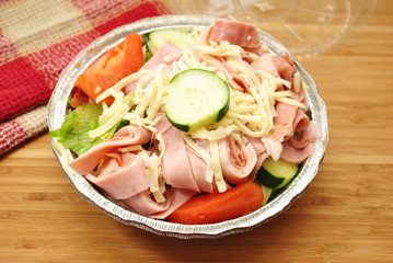 Appetizing Takeout Salad with Vegetables, Meat and Cheese 