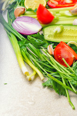 Fresh vegetables. Сoncept of healthy eating.Vegetables. Still life of fresh fruits: pepper, lemon, tomato, cucumber, onion, green onion, parsley, garlic, celery.