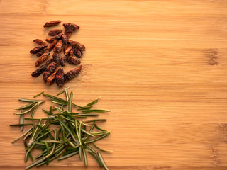 Spicy cayenne and rosemary herb on a wooden table