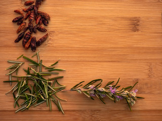 Spicy cayenne and rosemary herb on a wooden table