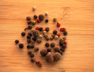 Five peppers mix on a wooden table