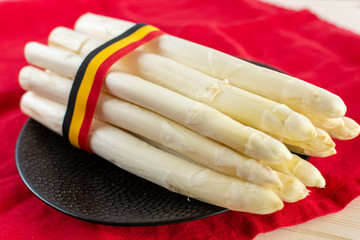 New harvest of white asparagus, high quality Belgian asparagus with ribbon in colors of Belgian flag