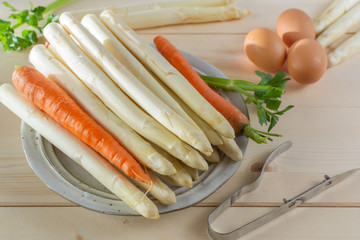New harvest of white asparagus, high quality raw asparagus, carrot and selery in spring season, ready to cook