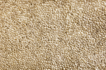 Old beige mosaic wall background texture