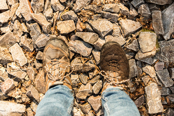 Asturias, Spain. Pair of boots over the stones and rocks in the Muniellos Nature Reserve (Reserva natural integral)
