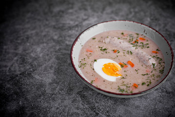 Easter breakfast. Sour rye soup with eggs and sausage