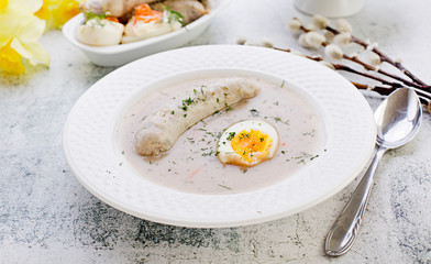 Easter breakfast. Sour rye soup with eggs and sausage