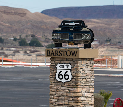 Highway marker for the famous RT66 in barstow California show the highway symbol and a muscle car.  Barstow Ca. 3/16/2018