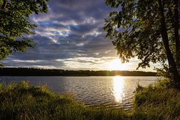 Summer Sunrise With Cloudy Sky Over Lake