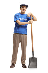 Elderly man volunteering with a shovel