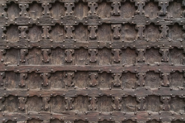Old wooden door with metal rivets