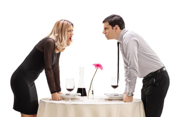 Young man and woman having an argument at a restaurant table