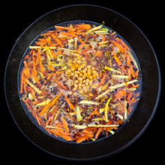 Rice pilaf in a large cast-iron cauldron on fire