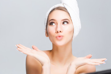 Portarait of perfect natural skin , young model with towel on hean have a cosmetics treatments! Patces on her cheeks.