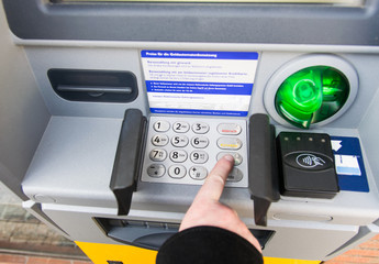 A tourist withdraws money from the ATM for travel.