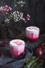 Beetroot latte. Healthy beetroot drink on table close up.