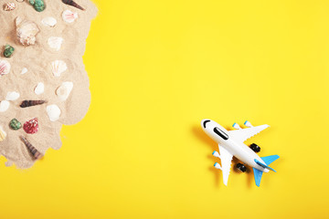 Flat lay design of travel concept with plane on yellow background with copy space. 