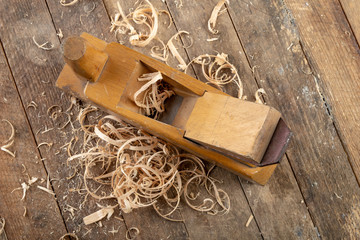 Old planer on a wooden carpentry table. DIY accessories in an old workshop.